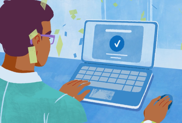 A person is at their laptop submitting a college applicaiton.