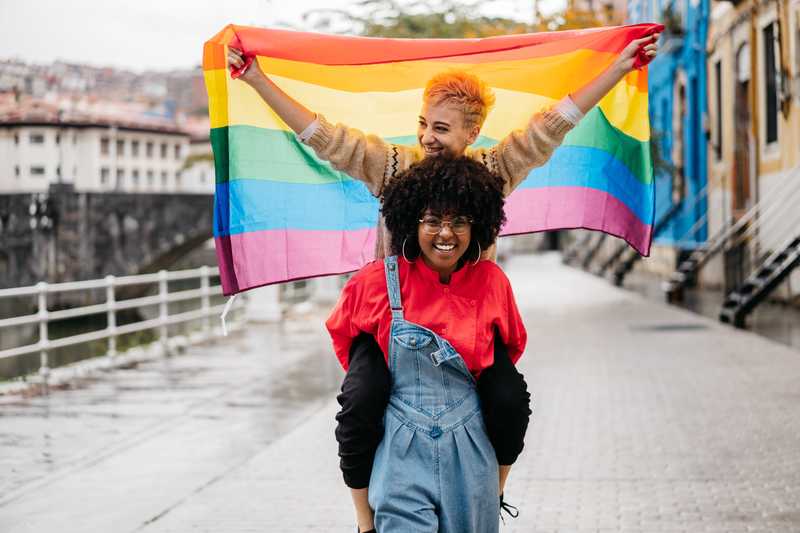 Students waving LGBTQ flag