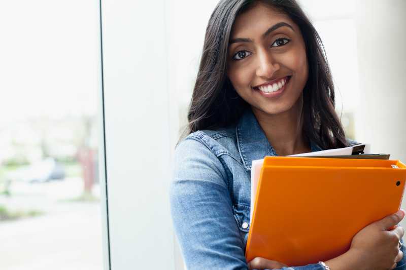 woman smiling with laptop computer