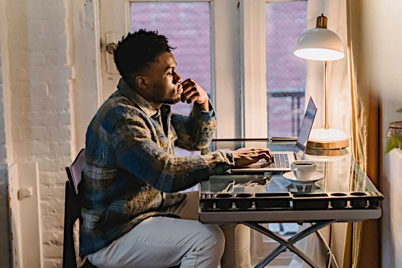 man at desk with laptop