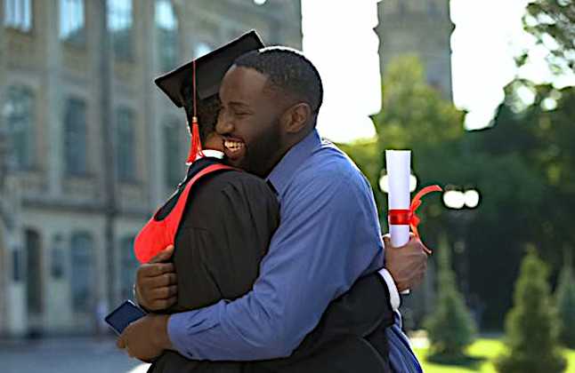 father and son embracing at graduation