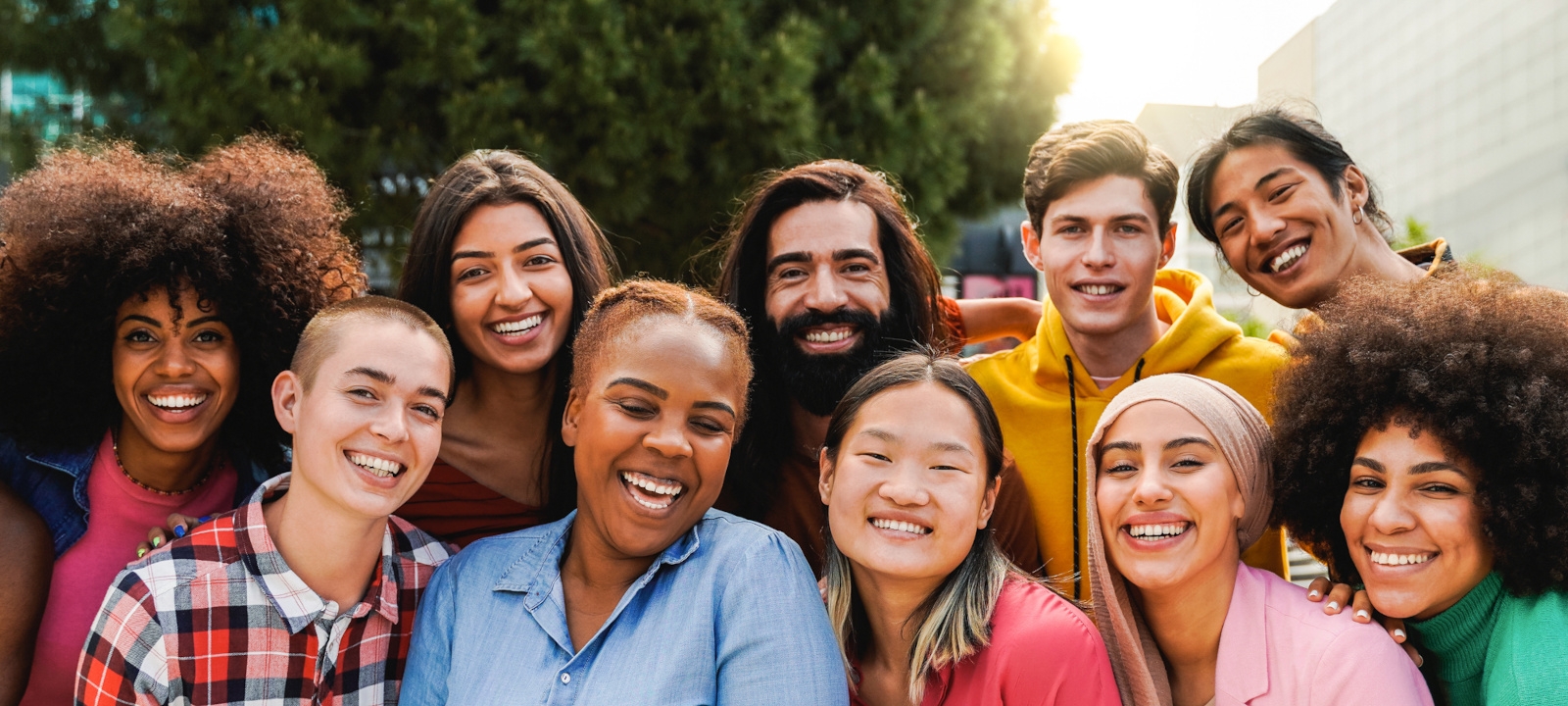 A group of diverse students smiling at the camera.