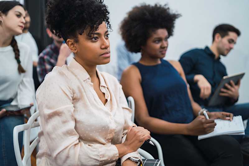 A group of people are watching a presenter. 