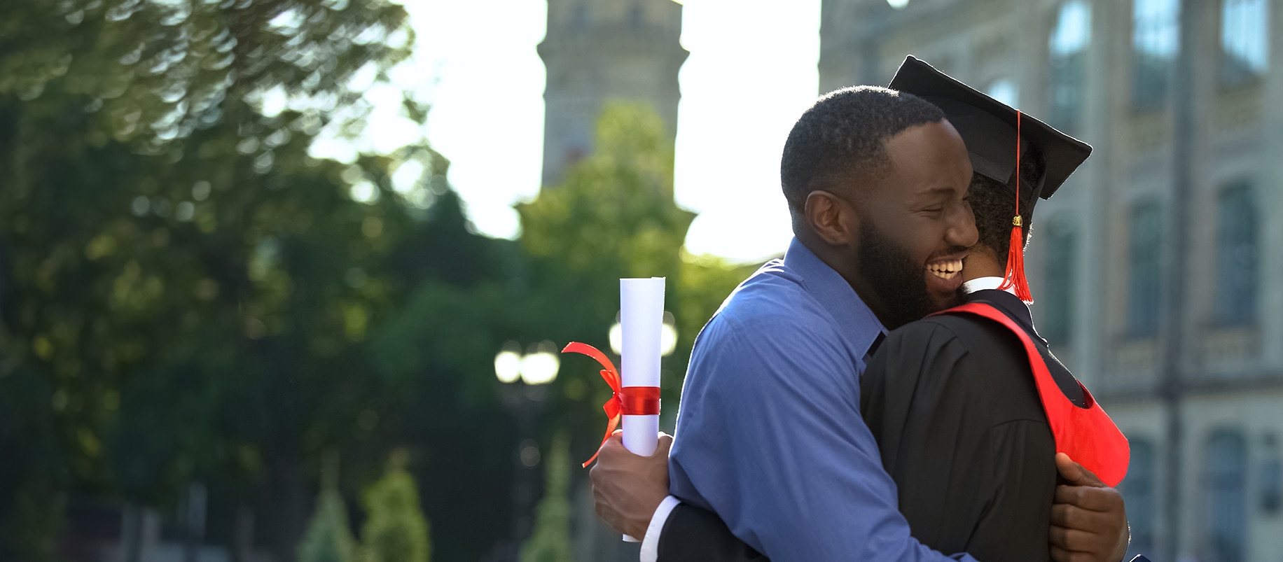father and son embracing at college graduation