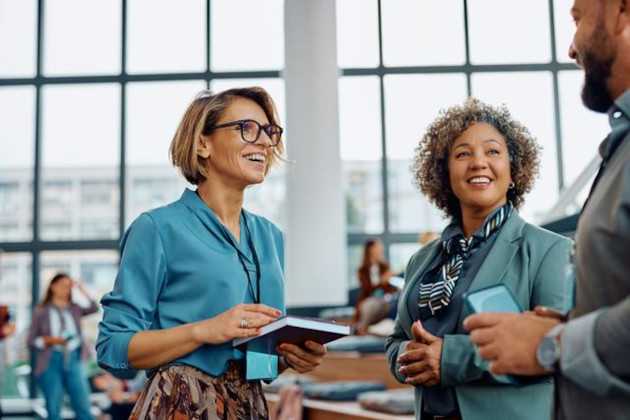 A group of people networking at a conference. 