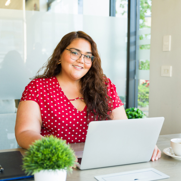A woman is working at a laptop.